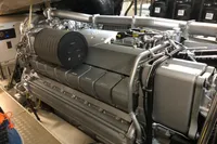 Engine room of a 2008 Pershing 90 yacht, showcasing a powerful marine engine.