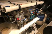 Engine room of a 2008 Pershing 90 yacht, featuring complex machinery and piping.