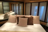 Luxurious bedroom interior of 2008 Pershing 90 yacht with plush pillows and elegant decor.