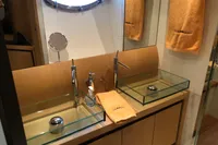Luxury bathroom with dual glass sinks in 2008 Pershing 90 yacht.