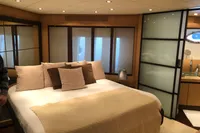 Luxurious bedroom interior on 2008 Pershing 90 yacht, featuring elegant design and cozy bedding.
