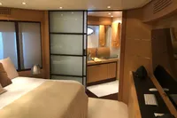 Luxurious bedroom and bathroom interior of a 2008 Pershing 90 yacht, featuring modern design.