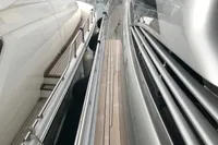 Side view of a 2008 Pershing 90 yacht docked at a marina.