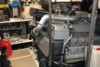 Engine room of a 2008 Pershing 90 yacht, showcasing machinery and equipment.