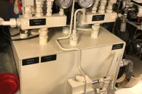 Hydraulic system in a 2008 Pershing 90 yacht engine room with gauges and pipes.