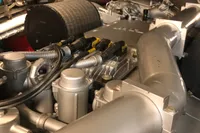 Engine room of a 2008 Pershing 90 yacht, showcasing complex machinery and components.