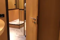 Interior of 2008 Pershing 90 yacht with wooden doors and mirrored walls.