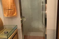 Luxurious bathroom shower in a 2008 Pershing 90 yacht, featuring modern design and amenities.