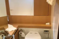 Luxury bathroom on a 2008 Pershing 90 yacht with modern fixtures and porthole window.