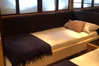 Luxurious twin bedroom in 2008 Pershing 90 yacht with elegant decor.