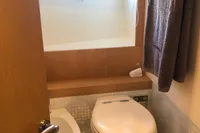 Bathroom interior of 2008 Pershing 90 yacht with porthole and towel.