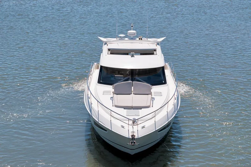  Yacht Photos Pics 2020 Riviera 4800 Sport Yacht cruising on calm waters, front view.
