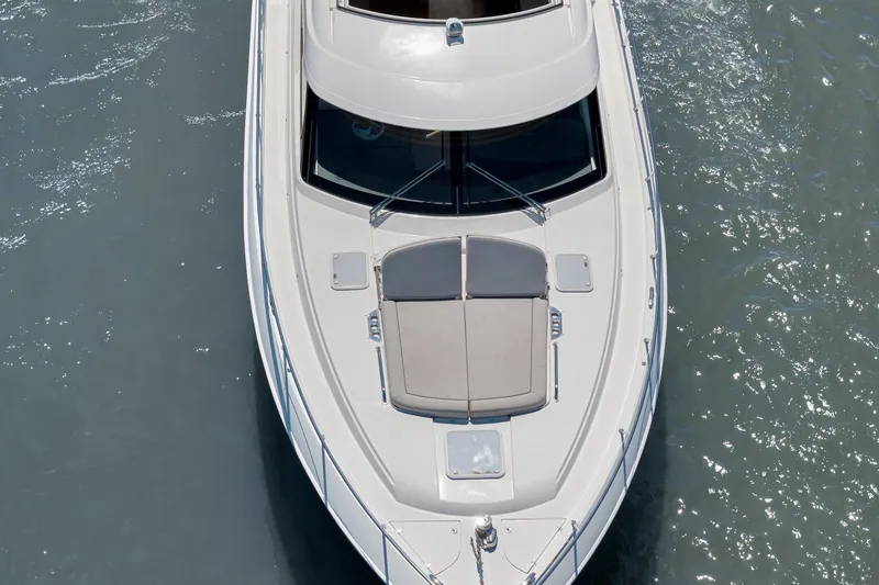  Yacht Photos Pics 2020 Riviera 4800 Sport Yacht cruising on calm waters, aerial view.