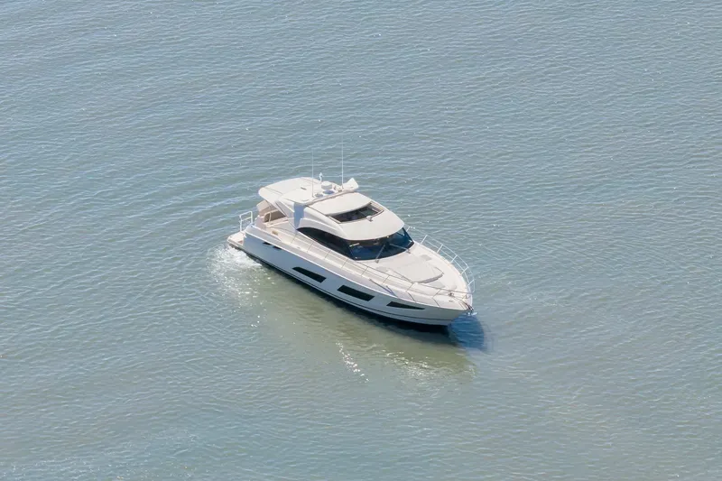  Yacht Photos Pics Aerial view of 2020 Riviera 4800 Sport Yacht cruising on calm water.