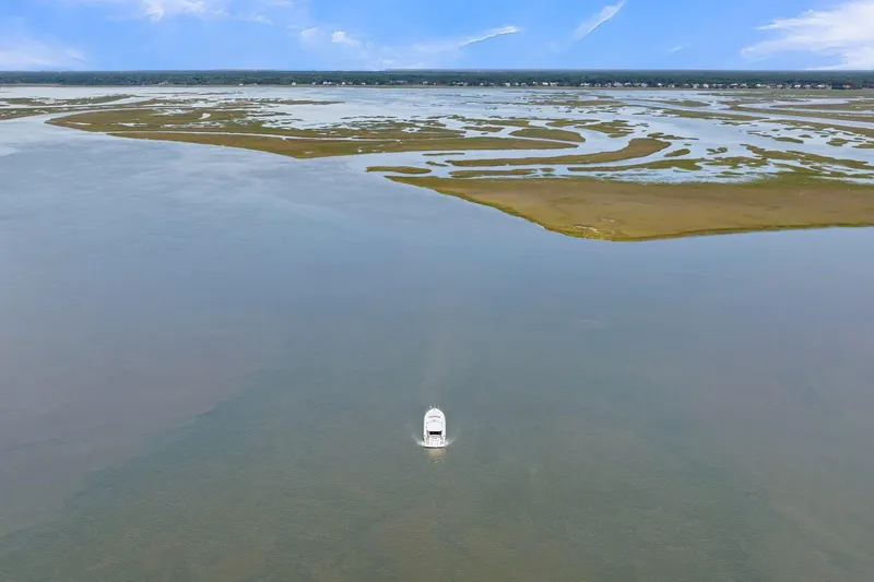  Yacht Photos Pics Aerial view of 2020 Riviera 4800 Sport Yacht navigating serene waters.