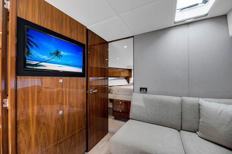  Yacht Photos Pics Luxurious interior of 2020 Riviera 4800 Sport Yacht with wood paneling and modern furnishings.