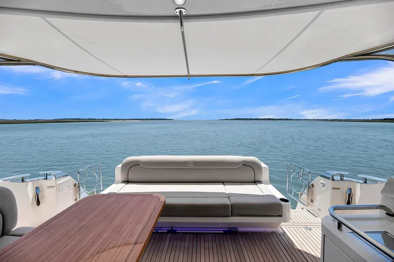  Yacht Photos Pics 2020 Riviera 4800 Sport Yacht with ocean view, featuring luxurious seating and sleek design.