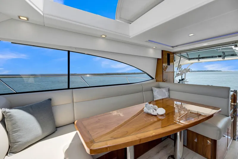  Yacht Photos Pics Luxurious interior of 2020 Riviera 4800 Sport Yacht with elegant seating and ocean view.