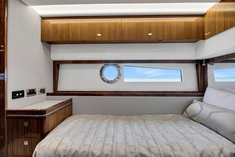 Yacht Photos Pics Luxurious cabin interior of 2020 Riviera 4800 Sport Yacht with wood finishes and ocean view.