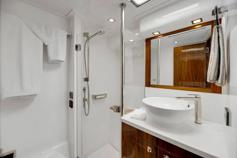  Yacht Photos Pics Luxurious bathroom in 2020 Riviera 4800 Sport Yacht with modern fixtures and elegant design.