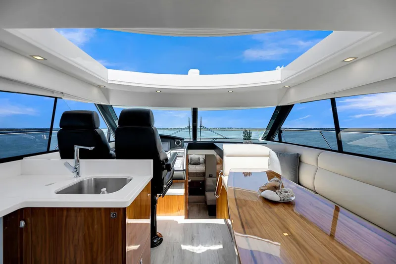  Yacht Photos Pics Luxurious interior of 2020 Riviera 4800 Sport Yacht with panoramic windows and sleek design.