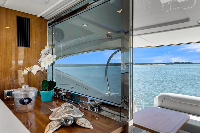  Yacht Photos Pics Luxurious interior of 2020 Riviera 4800 Sport Yacht with ocean view and elegant decor.