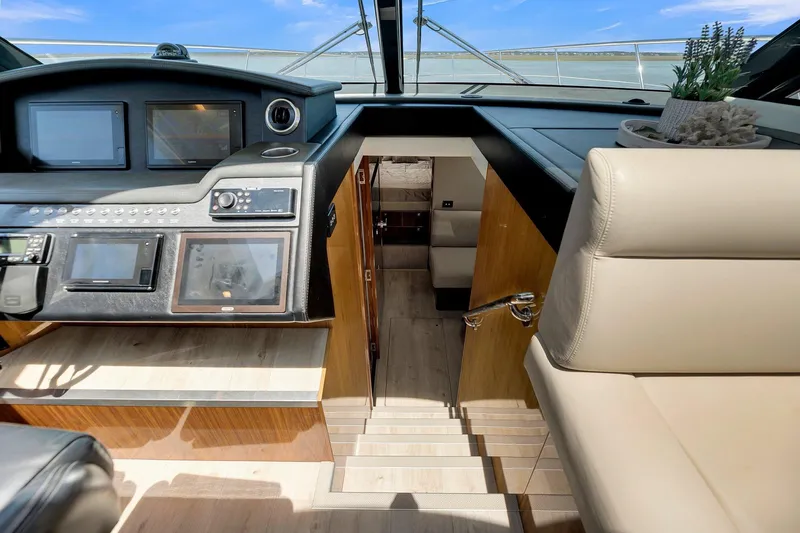  Yacht Photos Pics Interior view of 2020 Riviera 4800 Sport Yacht helm and cabin entrance.