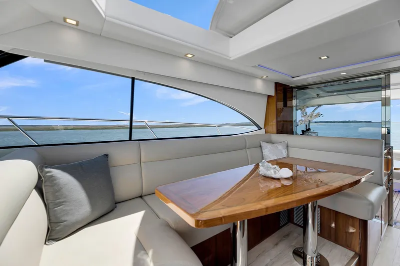  Yacht Photos Pics Luxurious interior of 2020 Riviera 4800 Sport Yacht with elegant seating and ocean view.