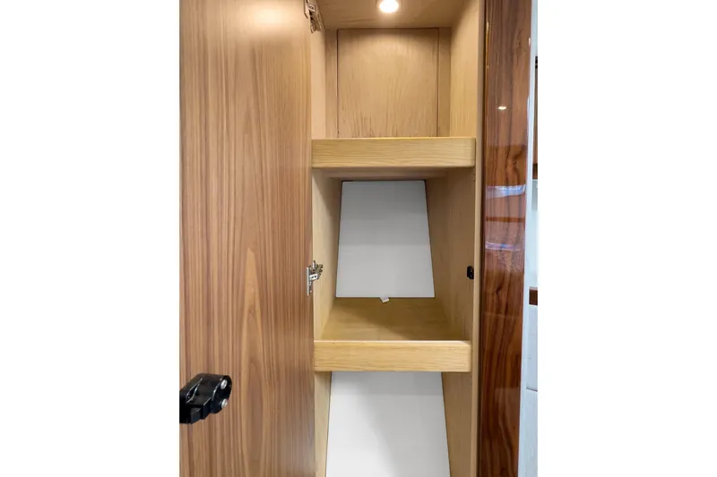  Yacht Photos Pics Wooden cabinet interior on 2020 Riviera 4800 Sport Yacht, featuring shelves and modern design.