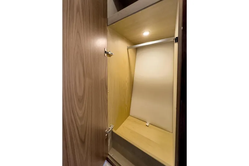  Yacht Photos Pics Interior closet of 2020 Riviera 4800 Sport Yacht with wooden finish and lighting.