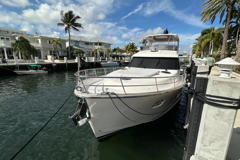 Our Trade Yacht Photos Pics Luxury 2023 Belize 54 Day Bridge yacht docked by waterfront homes.