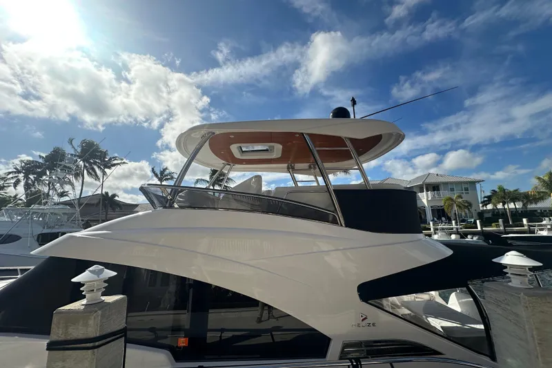 Our Trade Yacht Photos Pics Luxurious 2023 Belize 54 Day Bridge yacht docked under a sunny sky.