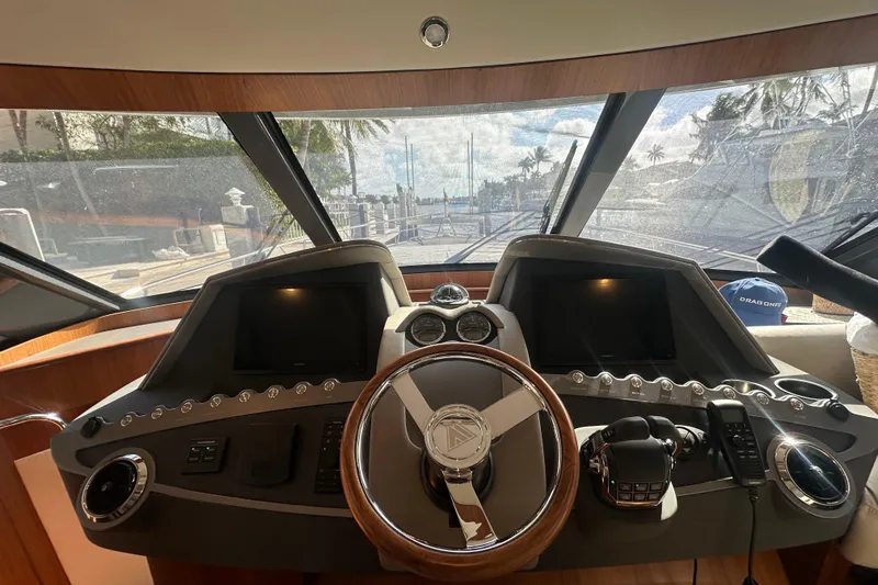 Our Trade Yacht Photos Pics Interior view of 2023 Belize 54 Day Bridge yacht helm with steering wheel and control panels.