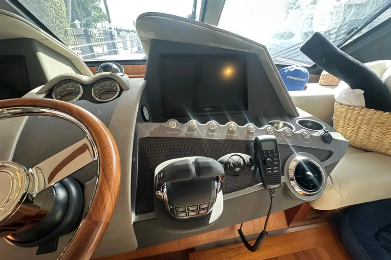 Our Trade Yacht Photos Pics Control panel of 2023 Belize 54 Day Bridge yacht with steering wheel and navigation instruments.