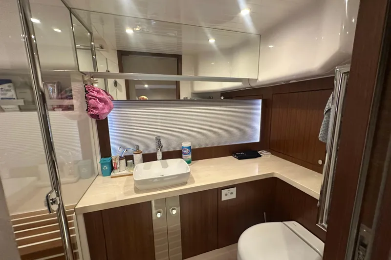 Our Trade Yacht Photos Pics Luxurious bathroom in 2023 Belize 54 Day Bridge yacht with modern fixtures and wooden cabinetry.