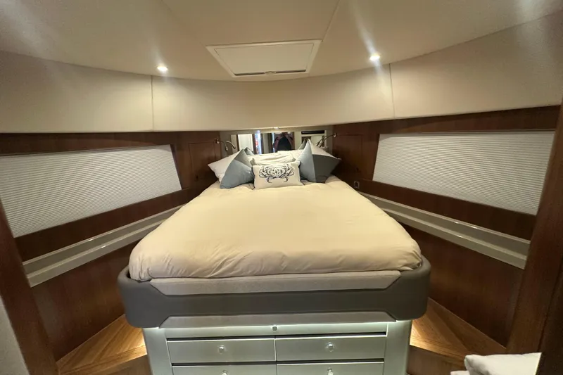 Our Trade Yacht Photos Pics Luxurious bedroom interior of 2023 Belize 54 Day Bridge yacht, featuring elegant bedding and wood accents.