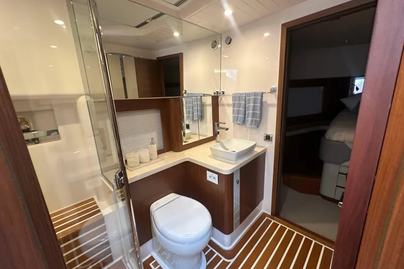 Our Trade Yacht Photos Pics Luxurious bathroom in 2023 Belize 54 Day Bridge yacht, featuring modern fixtures and elegant wood accents.