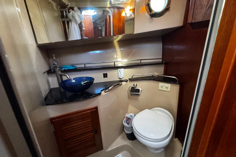 My Backyard Yacht Photos Pics 2014 Ranger Tugs R-31 CB bathroom with modern sink, toilet, and porthole window.