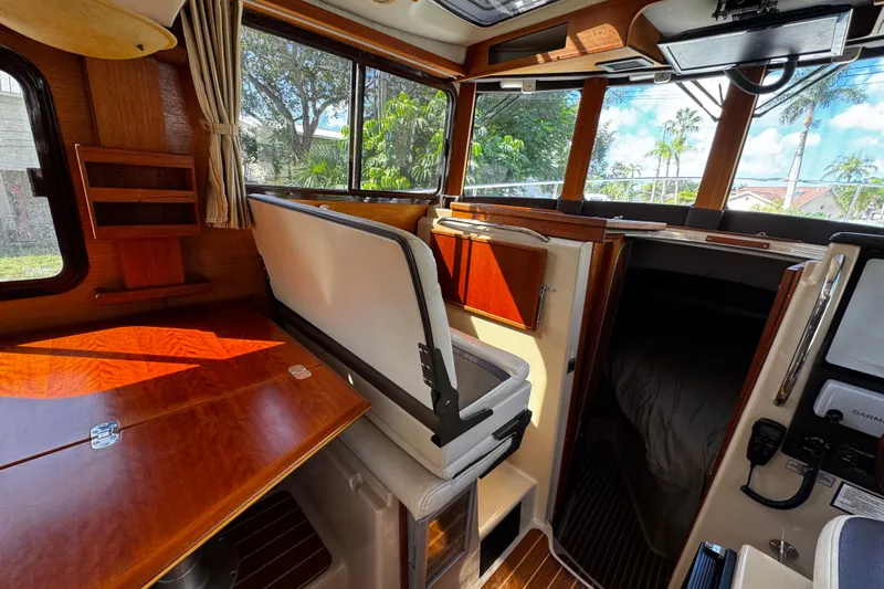 My Backyard Yacht Photos Pics Interior of 2014 Ranger Tugs R-31 CB boat with wood finishes and seating area.