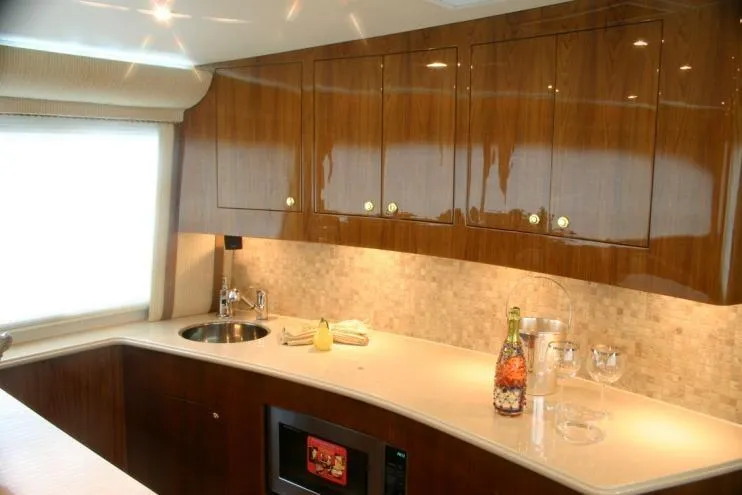  Yacht Photos Pics Luxurious kitchen interior of 2026 Buddy Davis 58 Sportfisherman yacht with sleek cabinetry.