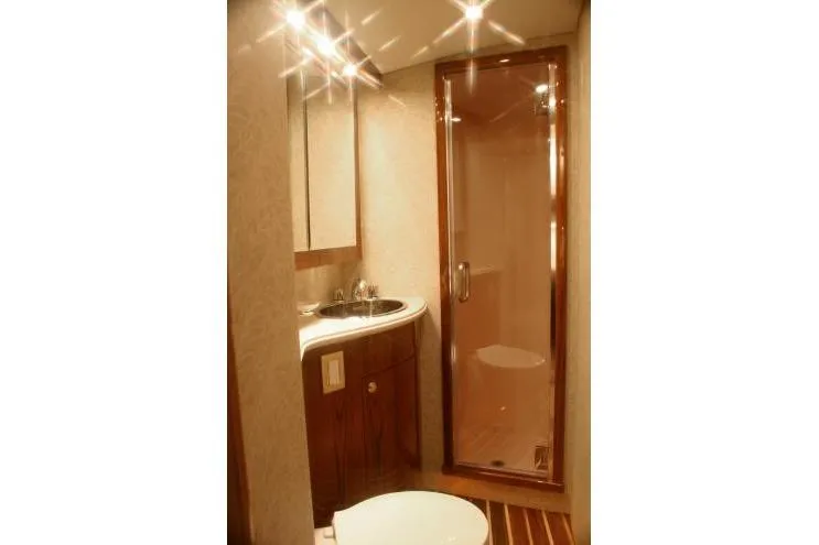 Yacht Photos Pics Luxurious bathroom in 2026 Buddy Davis 58 Sportfisherman yacht, featuring elegant wood finishes.