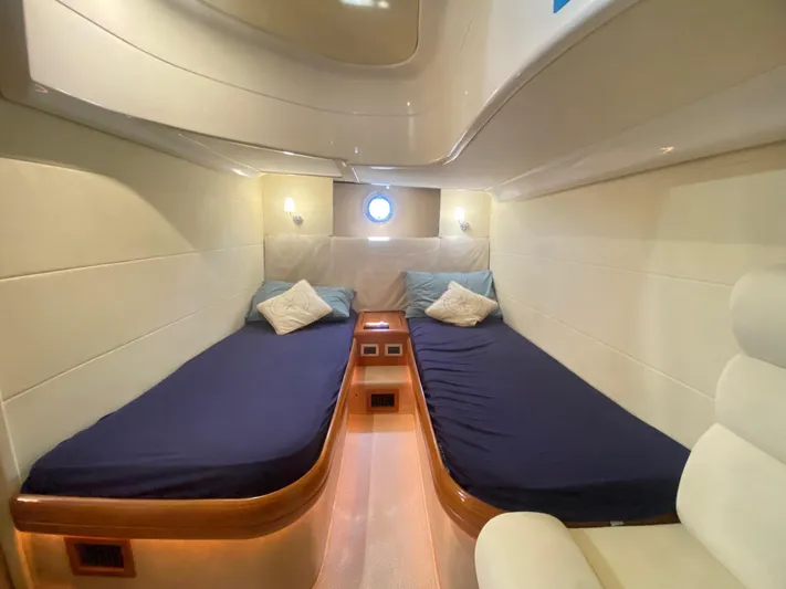  Yacht Photos Pics Interior cabin of 2006 Cranchi Mediterranee 47 yacht with twin beds and porthole.