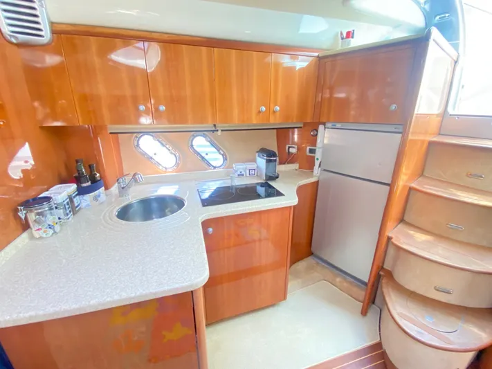  Yacht Photos Pics Luxurious 2006 Cranchi Mediterranee 47 yacht kitchen with wood cabinets and modern appliances.