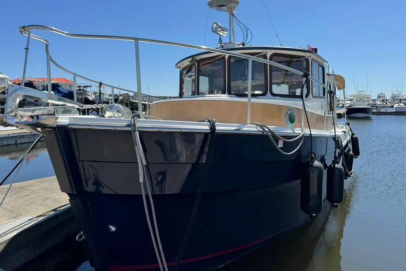 Point Aft'r Yacht Photos Pics 2012 Ranger Tugs R-29 boat docked in marina under clear blue sky.