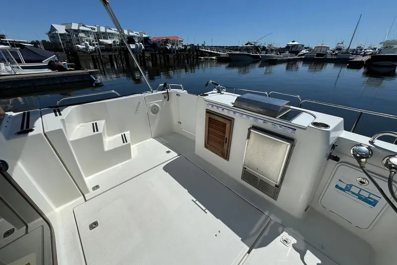 Point Aft'r Yacht Photos Pics 2012 Ranger Tugs R-29 boat deck with marina view, featuring storage and seating.