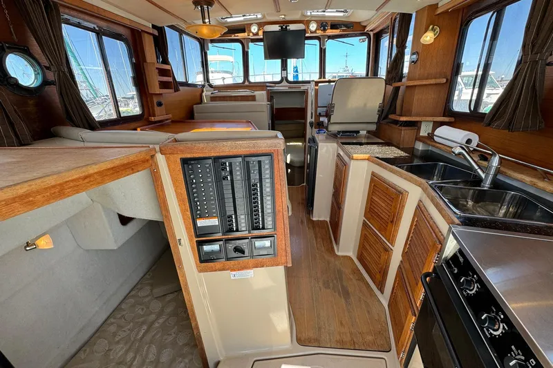 Point Aft'r Yacht Photos Pics Interior of 2012 Ranger Tugs R-29 boat, featuring kitchen and control panel.