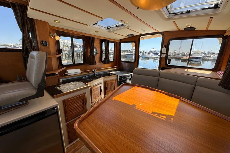 Point Aft'r Yacht Photos Pics Interior of 2012 Ranger Tugs R-29 boat with wood finishes and marina view.
