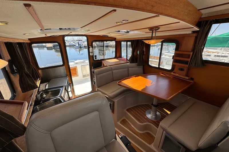 Point Aft'r Yacht Photos Pics Interior of 2012 Ranger Tugs R-29 boat with dining area and kitchenette.