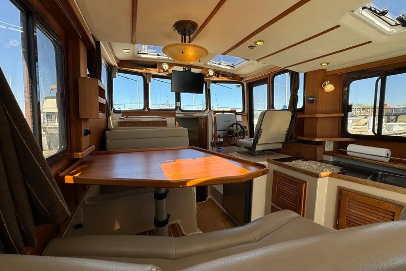 Point Aft'r Yacht Photos Pics Interior of 2012 Ranger Tugs R-29 boat with wood accents and seating area.