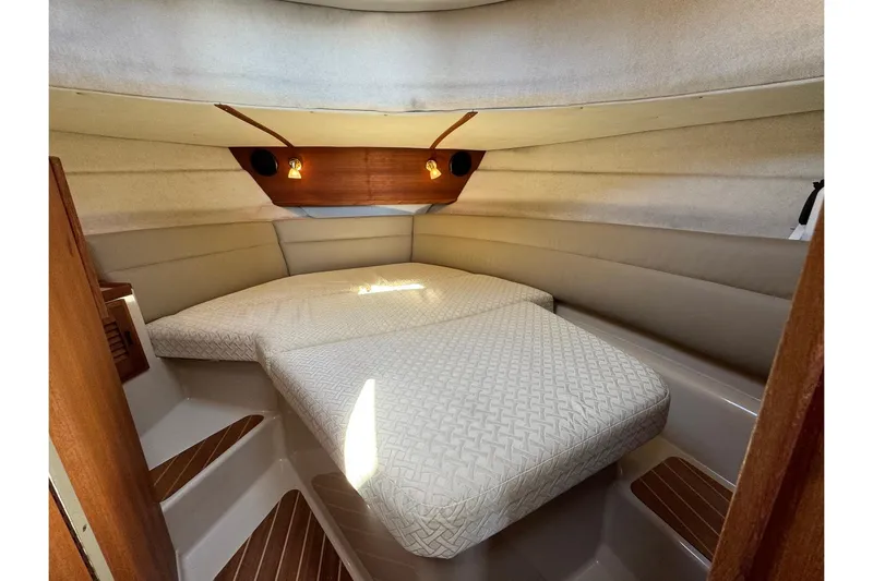 Point Aft'r Yacht Photos Pics Cozy cabin interior of 2012 Ranger Tugs R-29 with comfortable bedding and warm lighting.